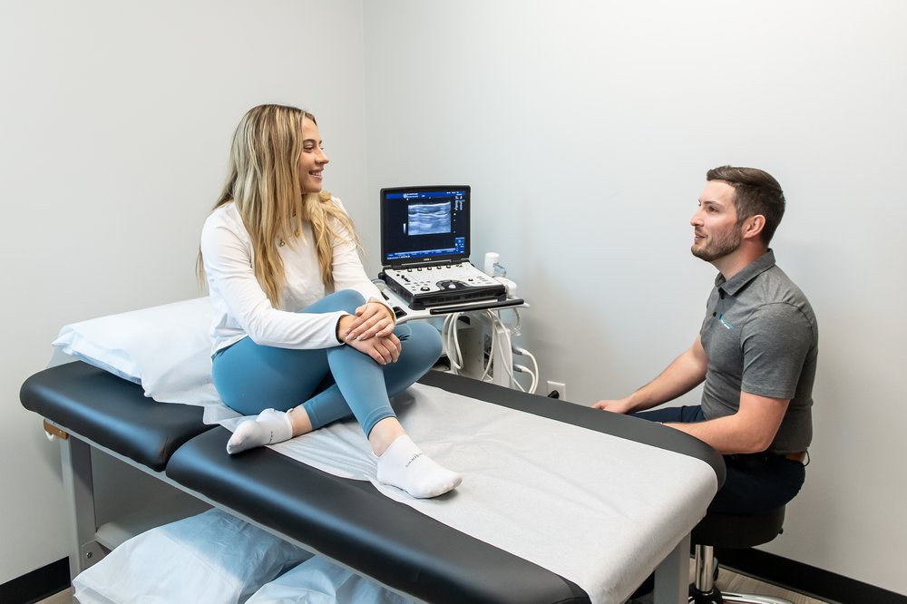 a physical therapist talks with a client